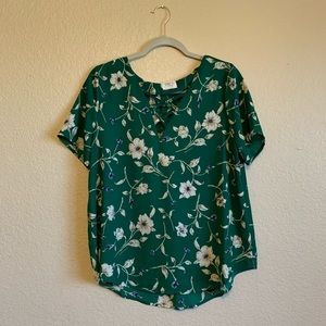 Green and white floral blouse